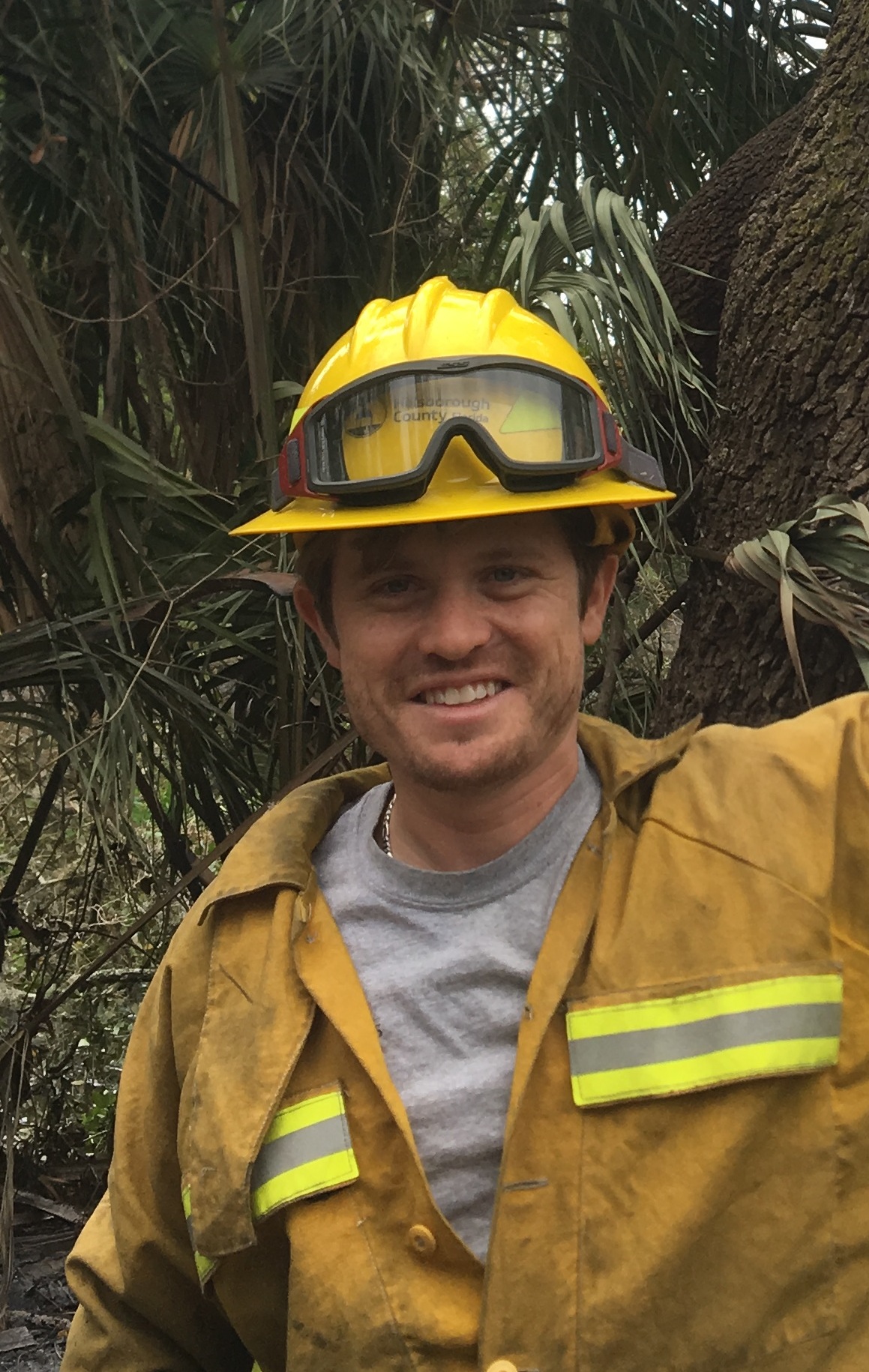 Me in front of river tractor tree burn